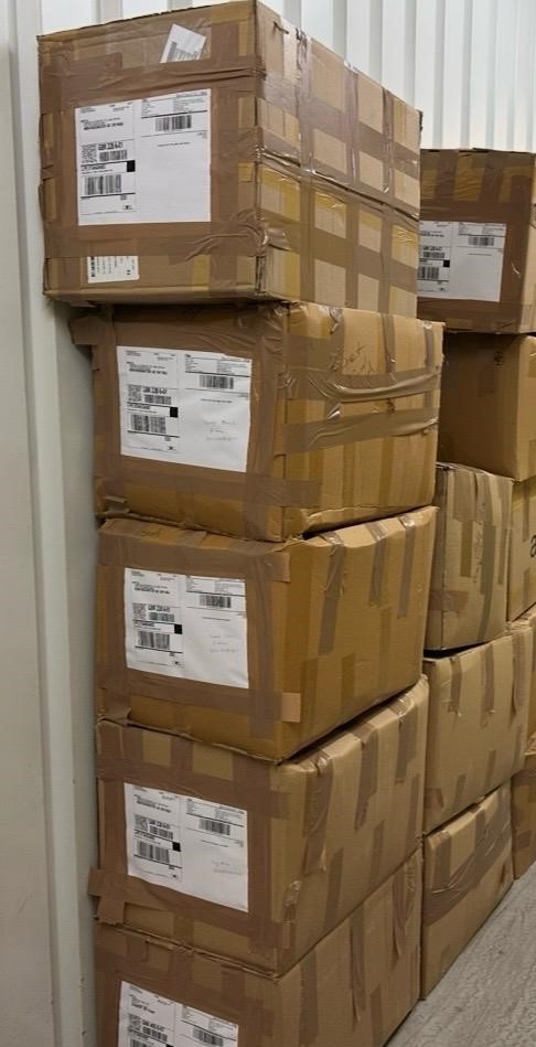 Interior of the TERA Fulfilment London warehouse with a packing bench and organised shelving